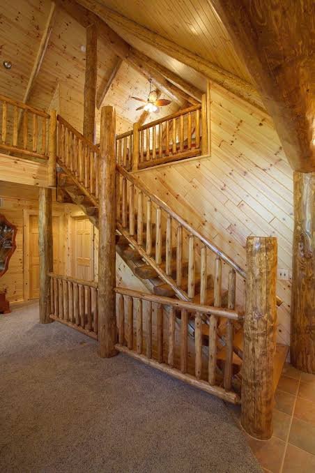 Rustic log cabin staircase with horizontal log railings and wooden spindles Rustic log cabin staircase with horizontal log railings and wooden spindles